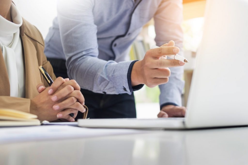Man and Woman Behind Laptop